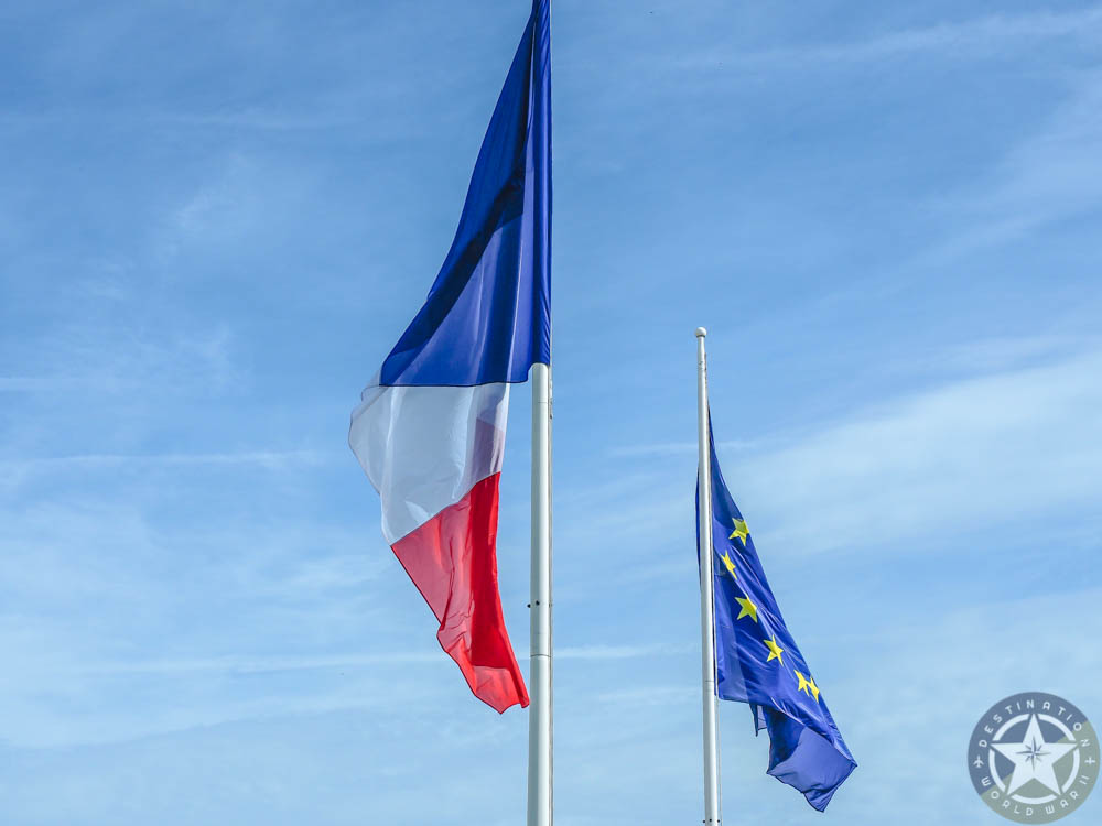 french and EU flag under a blue sky