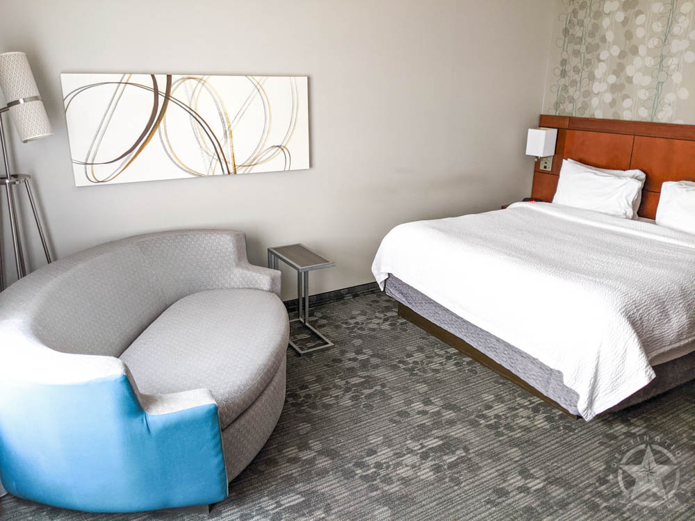 hotel room with bed and couch