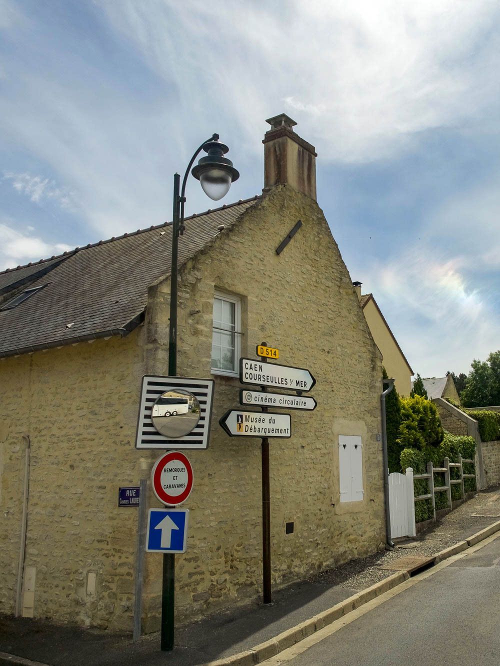old stone building and street signs