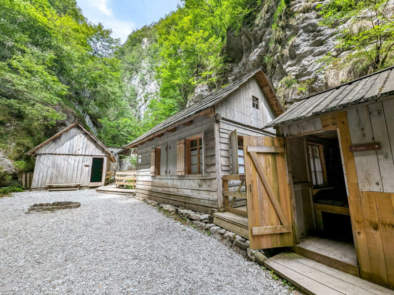 group of wooden buildings built into a rocky gorge