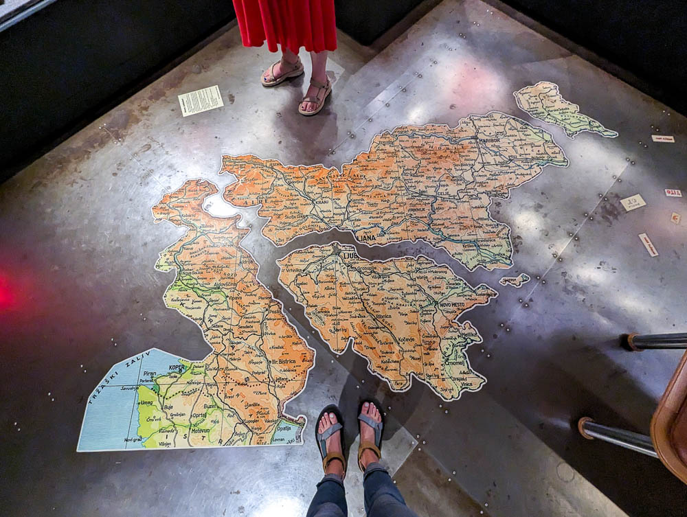 standing over a divided map of slovenia