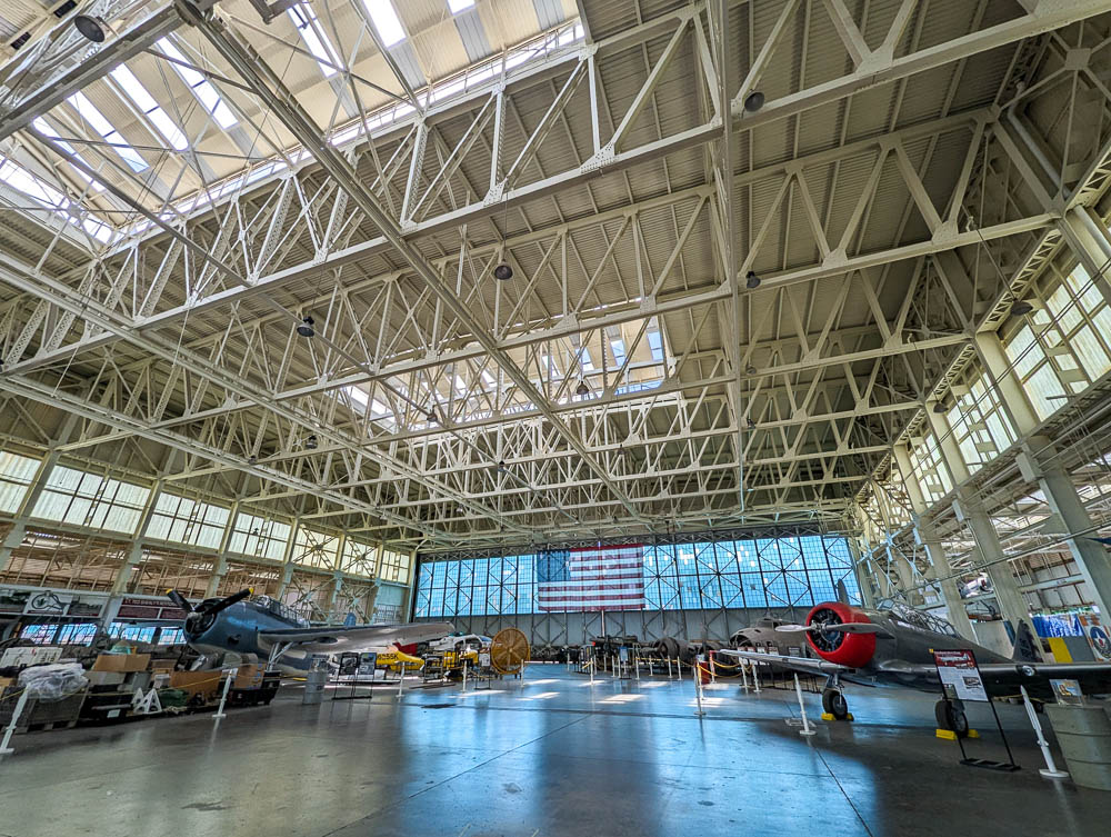 inside a large airplane hangar filled with planes