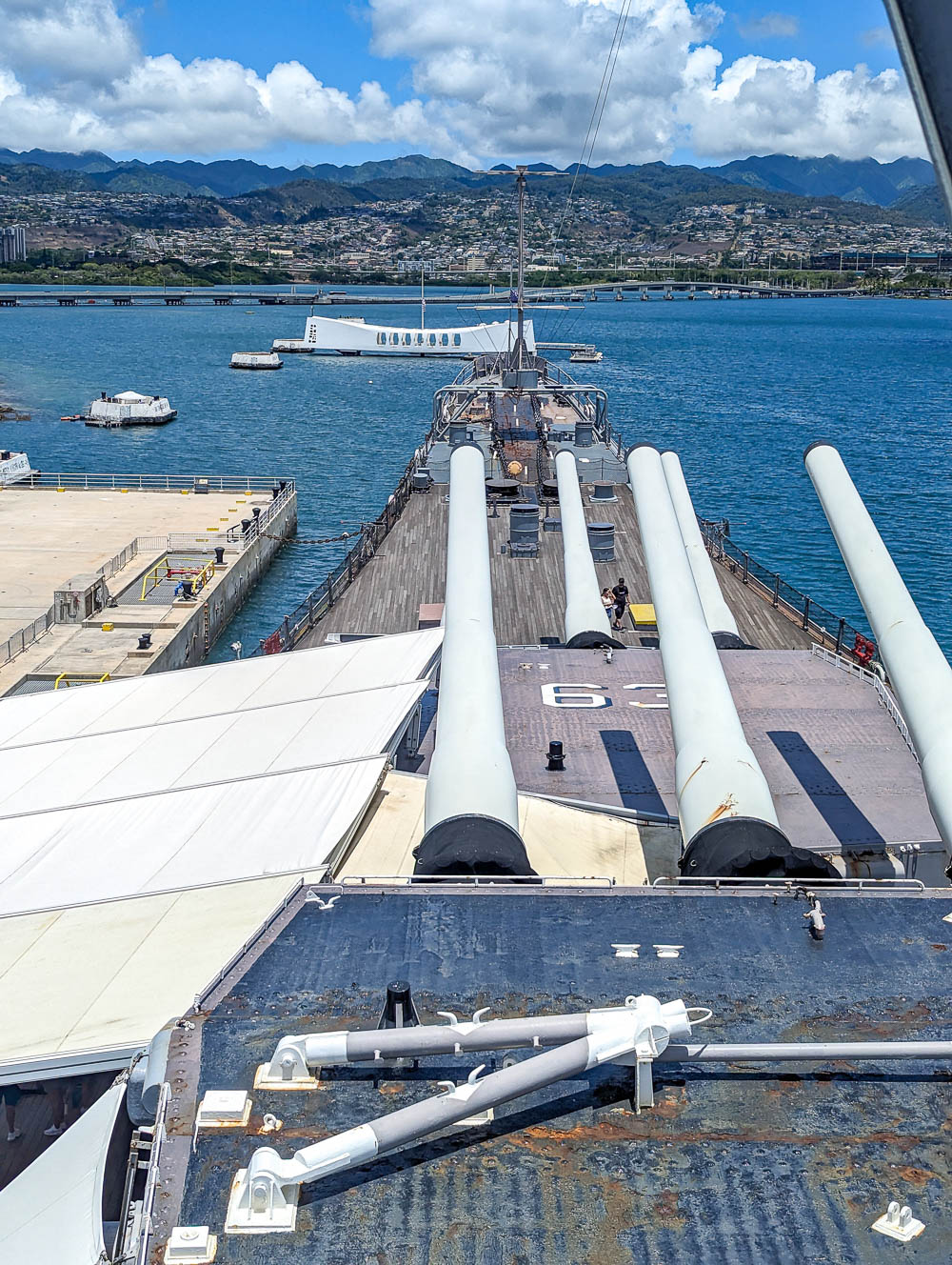 looking out at the uss arizona memorial from the top of a battleship