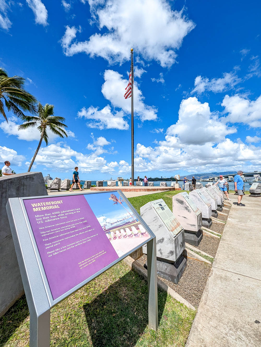 view of a waterfront memorial under a blue sky dotted with clouds