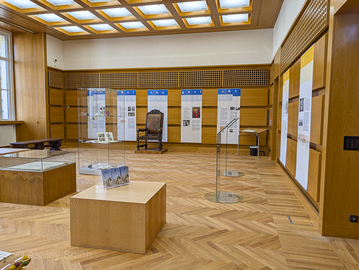 wood-paneled courtroom with museum displays inside