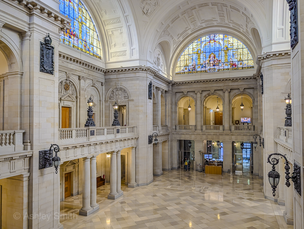 inside a large fancy building with columns and stained glass windows