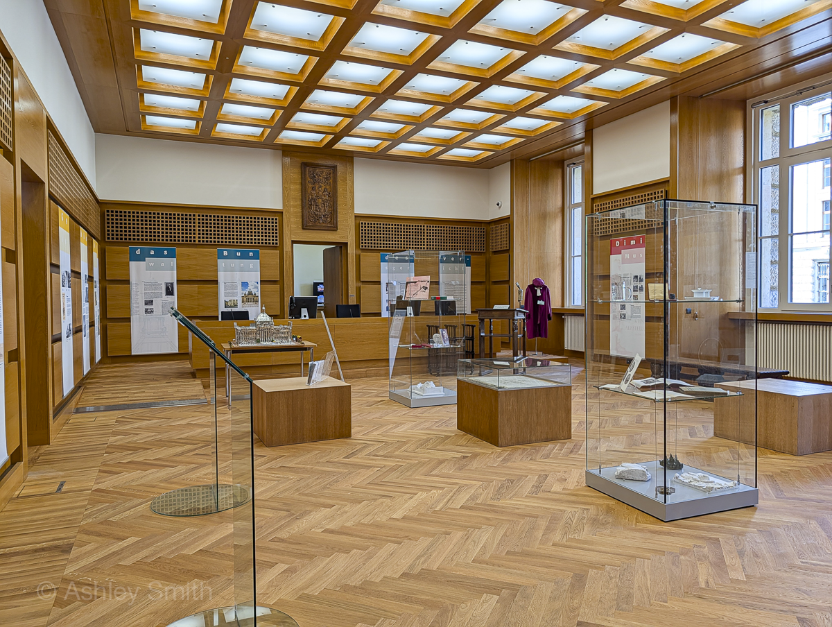 wood-paneled courtroom with museum displays inside