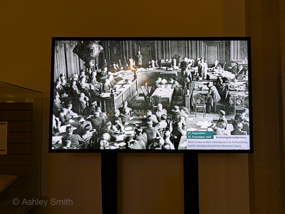 screen showing a historical photograph of the trial happening